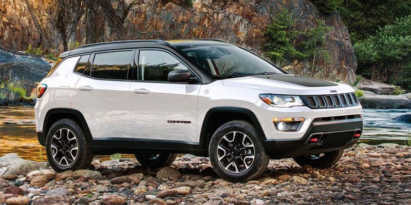white 2021 jeep compass right side angle view parked beside a river