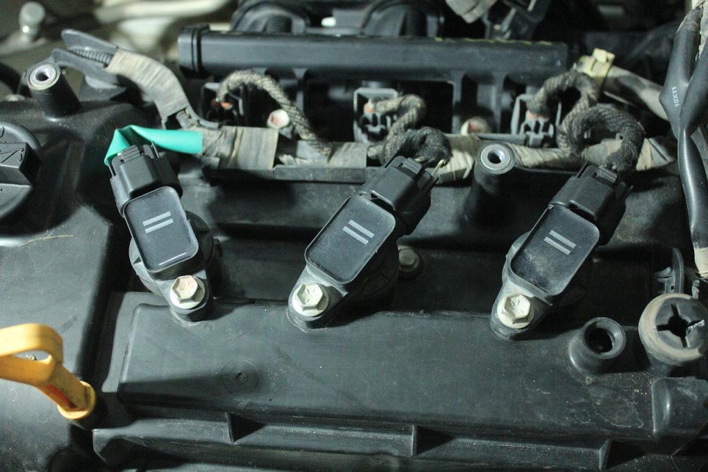 Ignition coils attached to a car engine in  Dickinson, ND
