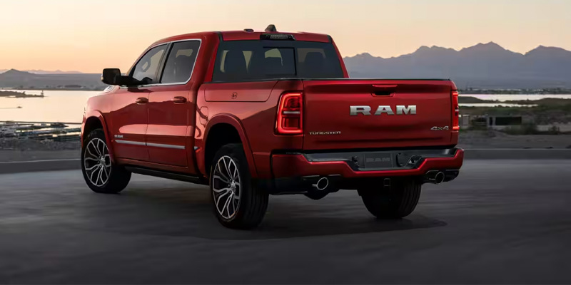 Red Ram pickup truck on a scenic road.